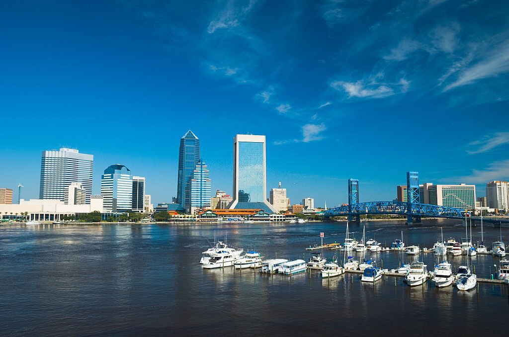 Jacksonville Downtown skyline, St. Johns River, Main Street Bridge, and a marina full of yachts.